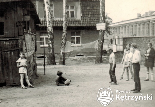 Grupa dzieci na podwórku ówczesnej posesji ul. Traugutta 10 (obecnie nr 23), w głębi dom ul. Piwna 5, po prawej zabudowania browaru – 1967r.   